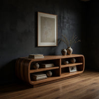 Rounded TV cabinet with four open cubbies in a dark studio against a charcoal wall