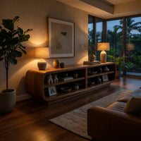 Rounded TV cabinet with four open cubbies in an evening room lit by two lamps