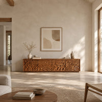 Long low tv stand with four doors carved in deep rippling wave relief in a bright open plan living room