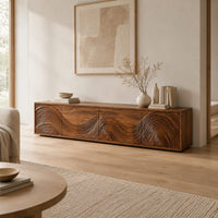 Tv stand with four doors carved in swirling wave ridges in a Scandinavian living room with white walls