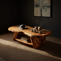 Figured wood free form coffee table with a lower shelf, three-quarter view showing the grain