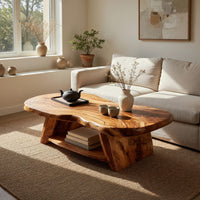 Figured wood free form coffee table with a lower shelf in a sunlit room with large windows and plants