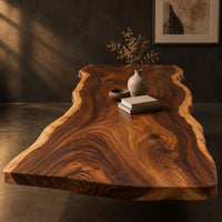 Long wood tabletop with uneven natural edges and bold swirling grain, three-quarter view showing the grain