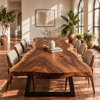 Long wood tabletop with uneven natural edges and bold swirling grain in a bright dining room with arched windows and plants