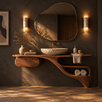 Floating freeform vanity cabinet with a small drawer and a flowing open niche in a dark bathroom at golden hour