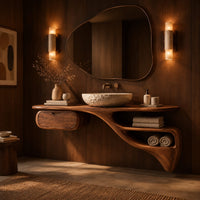 Floating freeform vanity cabinet with a small drawer and a flowing open niche in an evening bathroom with walnut wall paneling