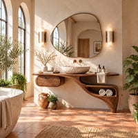 Floating freeform vanity cabinet with a small drawer and a flowing open niche in a bright bathroom with arched windows and plants