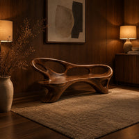 Long freeform bench with oval cutouts along the back and flared legs in an evening entryway with walnut wall paneling