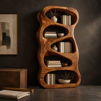 Corner detail of freeform wooden bookshelf with five stacked pebble shaped open cells beside wood, brass and linen samples