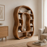 Freeform bookshelf with a keyhole shaped center opening and uneven shelves in a Scandinavian living room with white walls