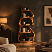 Freeform bookshelf with stacked oval cubbies in a tree trunk form in a dark living room at golden hour