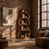 Freeform bookshelf with stacked oval cubbies in a tree trunk form in an industrial loft living room with exposed brick