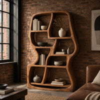 Freeform wooden bookshelf with uneven open cubbies and a soft outline in an industrial loft living room with exposed brick