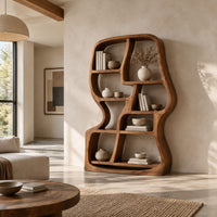 Freeform wooden bookshelf with uneven open cubbies and a soft outline in a bright open plan living room