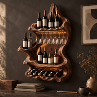 Corner detail of freeform carved wine holder with a peaked top and a scalloped lower row beside wood, brass and linen samples