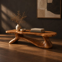 Freeform wooden coffee table with a sculpted branching base, three-quarter view showing the grain