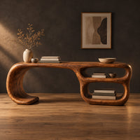 Freeform loop desk with a swooping end and stacked oval shelves in a dark studio against a charcoal plaster wall