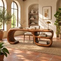 Freeform loop desk with a swooping end and stacked oval shelves in a bright home office with arched windows and plants