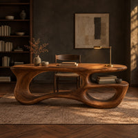 Freeform oval desk with an open loop base and a low shelf in a dark home office at golden hour