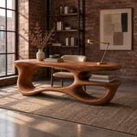 Freeform oval desk with an open loop base and a low shelf in an industrial loft home office with exposed brick