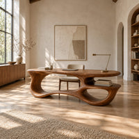 Freeform oval desk with an open loop base and a low shelf in a bright open plan home office