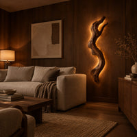 Tall wall sconce shaped like a gnarled twisting branch with a glowing halo in an evening living room with walnut wall paneling