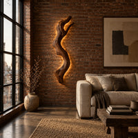 Tall wall sconce shaped like a gnarled twisting branch with a glowing halo in an industrial loft living room with exposed brick