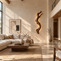 Tall wall sconce shaped like a gnarled twisting branch with a glowing halo in a bright open plan living room