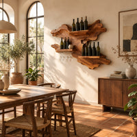 Organic wine rack with a gnarled outline, three shelves and a glass rail in a bright dining room with arched windows and plants