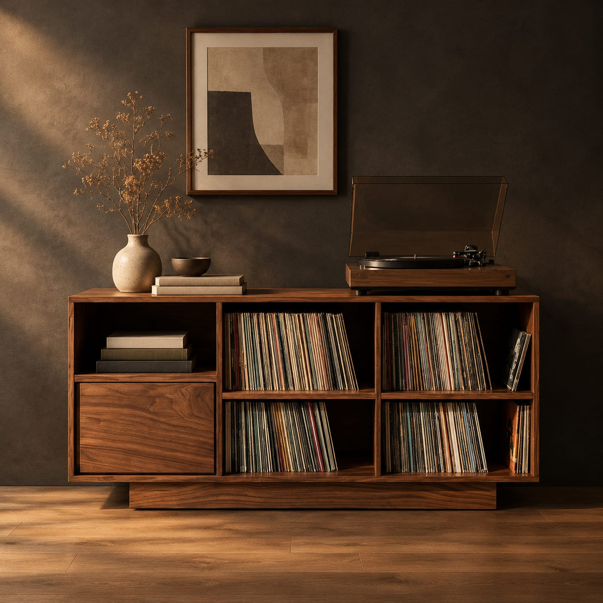 Low cabinet with a grid of open cubbies and a slim plinth base in a dark studio against a charcoal plaster wall