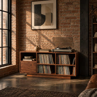 Low cabinet with a grid of open cubbies and a slim plinth base in an industrial loft living room with exposed brick