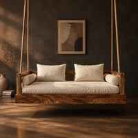 Hanging daybed swing with a thick wood base and low frame sides in a dark studio against a charcoal plaster wall