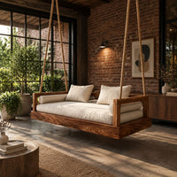 Hanging daybed swing with a thick wood base and low frame sides in an industrial loft porch with exposed brick