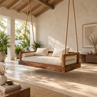 Hanging daybed swing with a thick wood base and low frame sides in a bright open plan porch