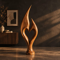 Flame sculpture with two pointed tips enclosing a heart shaped opening, three-quarter view showing the grain