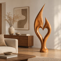Flame sculpture with two pointed tips enclosing a heart shaped opening in a Scandinavian living room with white walls