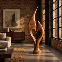 Flame sculpture with two pointed tips enclosing a heart shaped opening in an industrial loft living room with exposed brick