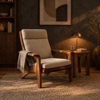 High back lounge chair with cushioned seat and sweeping wood arms in a dark living room at golden hour