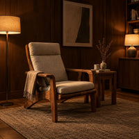 High back lounge chair with cushioned seat and sweeping wood arms in an evening living room with walnut wall paneling