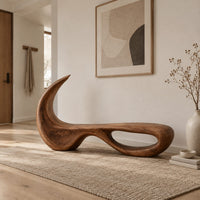 Sculpted bench with a hooked back and an open loop base in a Scandinavian entryway with white walls