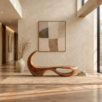 Sculpted bench with a hooked back and an open loop base in a bright open plan entryway