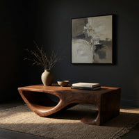 Dark coffee table with a scooped hollow and hooked end, three-quarter view showing the grain