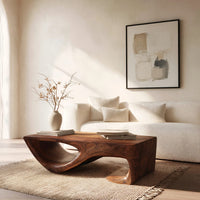 Dark coffee table with a scooped hollow and hooked end in a bright modern living room