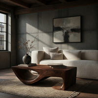 Dark coffee table with a scooped hollow and hooked end in a concrete and timber loft