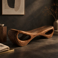 Corner detail of hourglass bench with a narrow middle and hollow oval ends beside wood, brass and linen samples
