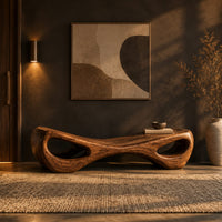 Hourglass bench with a narrow middle and hollow oval ends in a dark entryway at golden hour