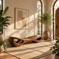 Hourglass bench with a narrow middle and hollow oval ends in a bright entryway with arched windows and plants