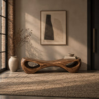 Hourglass bench with a narrow middle and hollow oval ends in an industrial loft entryway with exposed brick