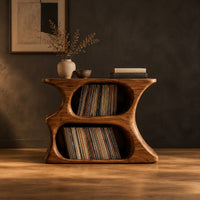 Hourglass record player stand with two stacked oval openings and a flat top in a dark studio against a charcoal plaster wall