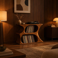 Hourglass record player stand with two stacked oval openings and a flat top in an evening living room with walnut wall paneling